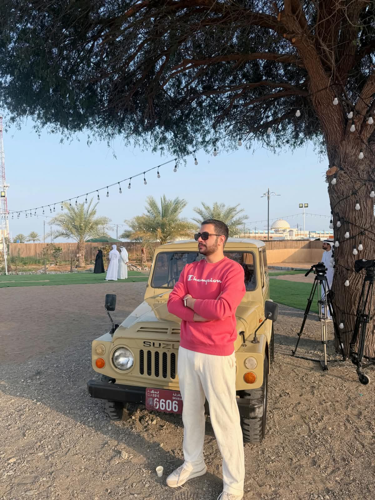 Maher outdoors beside a vehicle